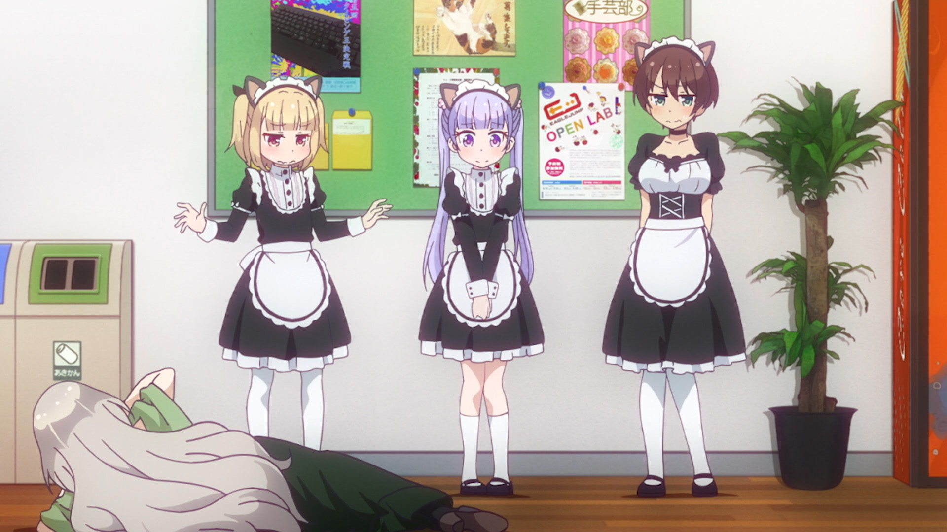The game director (on the floor) keeps maid costumes handy for, um, reasons