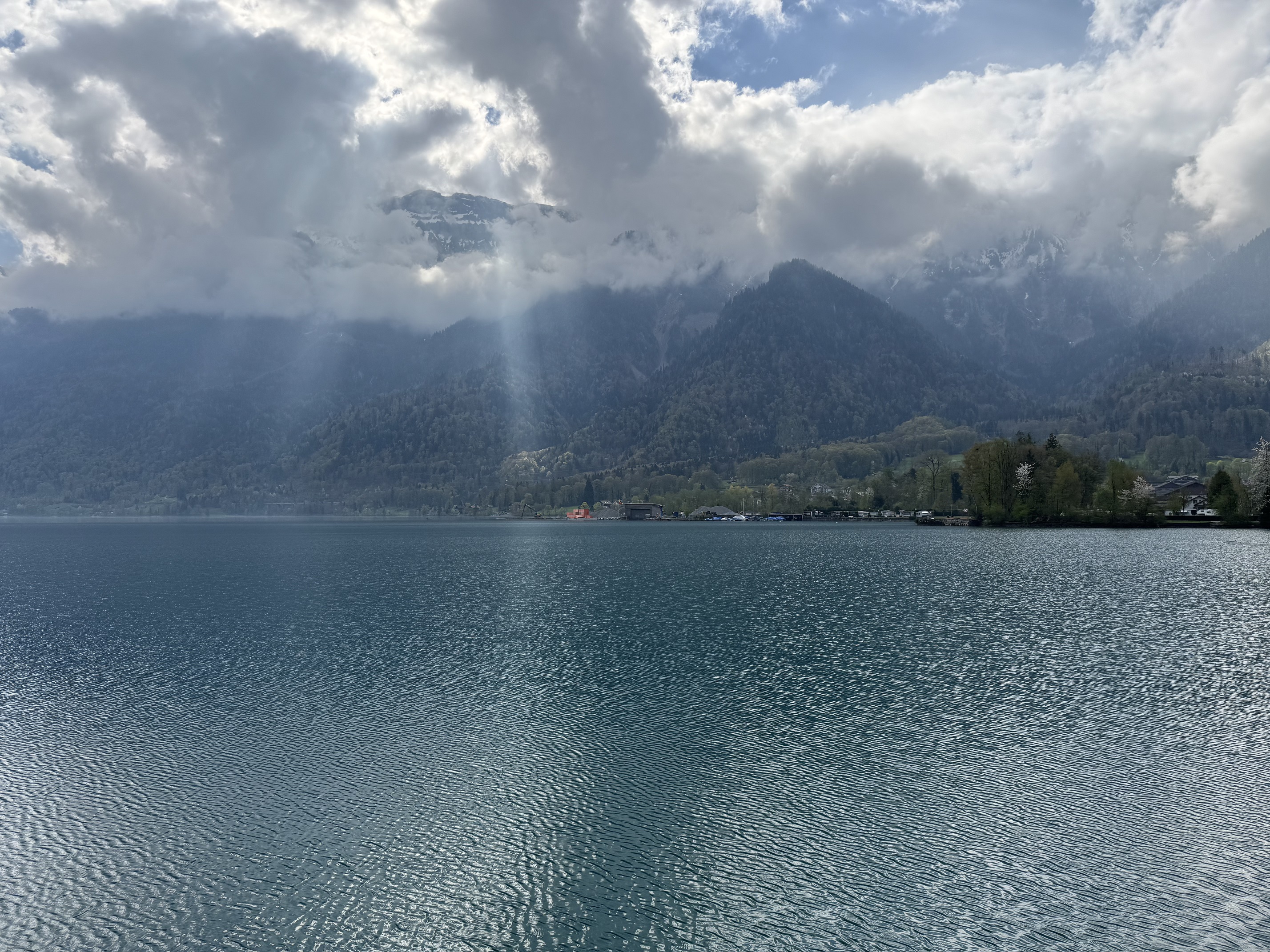 Sunlight breaks through the clouds above Lake Thun